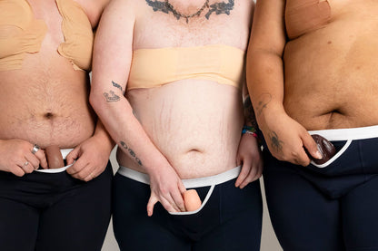 Three people wearing underwear with a neutral background